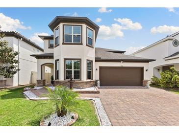 Charming home featuring a three-story tower, a two-car garage, and professional landscaping at 3138 Twin Shore Ln, Orlando, FL 32824