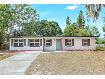 Charming single-story home with light blue door and gray shutters at 451 E 5Th St, Chuluota, FL 32766