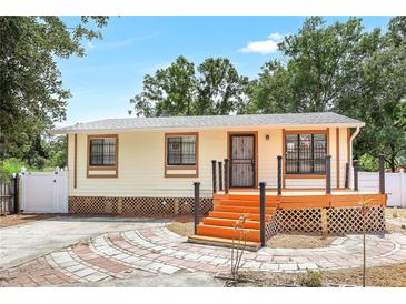 Charming single-story home with a freshly painted exterior and a landscaped walkway leading to the front door at 4922 Huppel Ave, Orlando, FL 32811