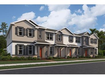 Charming townhomes showcasing a neutral color palette, covered entryways, and manicured landscaping along the front at 624 Pothos St, Apopka, FL 32703