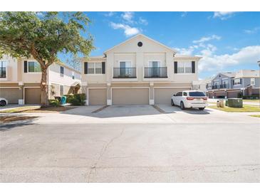 This is a shot of the home's exterior elevation, showing attached garages and small balconies at 6434 S Goldenrod Rd # 17B, Orlando, FL 32822