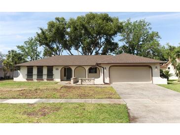 Charming single-story home with a 2 car garage, stucco exterior and well-maintained front lawn at 8830 Ladrido Ln, Orlando, FL 32836