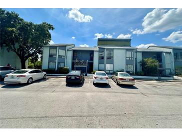 Exterior view of the apartment building with parking spaces, showcasing its architecture and location at 4350 Aqua Vista Dr # G, Orlando, FL 32839