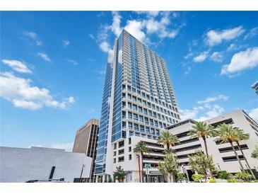 Modern high-rise building with sleek architecture and beautiful sky views in a vibrant city setting at 150 E Robinson St # 801, Orlando, FL 32801
