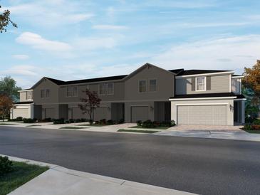 Charming two-story townhomes with attached garages and well-manicured landscaping create inviting curb appeal at 16430 Bird Of Paradise Ave, Clermont, FL 34714