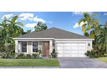 Charming single-story home with a two-car garage, complemented by tropical landscaping and a well-manicured lawn at 30338 Emerald Forest Dr, Mount Dora, FL 32757