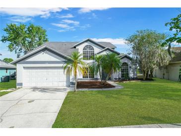 Charming two-story home featuring a well-manicured lawn, mature trees, and a spacious two-car garage at 11160 Sylvan Pond Cir, Orlando, FL 32825
