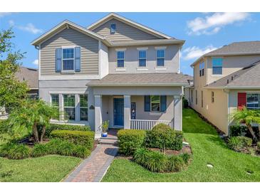Charming two-story home featuring manicured landscaping and a welcoming front porch at 16137 Azure Key St, Winter Garden, FL 34787