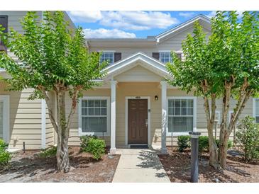 Inviting two-story home entrance with landscaped pathway and traditional architecture at 2952 Lucayan Harbour Cir # 106, Kissimmee, FL 34746