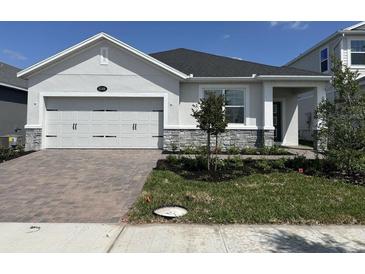 Charming single-story home featuring a two-car garage and a well-manicured front yard at 5268 Teirgarten St, St Cloud, FL 34771