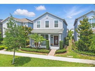 Charming two-story home with a manicured lawn, brick walkway, and inviting front porch at 12127 Sonnet Ave, Orlando, FL 32832