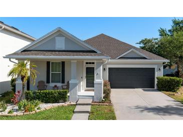 Charming single-story home featuring a well-maintained front yard and attached two-car garage at 13609 Riggs Way, Windermere, FL 34786