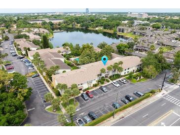 A beautiful aerial view of a condo community with lake, lush landscaping, and ample parking at 200 Maitland Ave # 224, Altamonte Springs, FL 32701