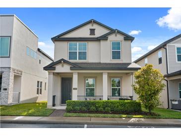 Charming two-story home featuring a covered front porch and well-maintained landscaping at 2405 Standing Rock Cir, Oakland, FL 34787