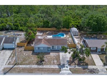 Charming home with a private backyard pool, surrounded by lush greenery and a wooden fence at 2763 E Waco Dr, Deltona, FL 32738