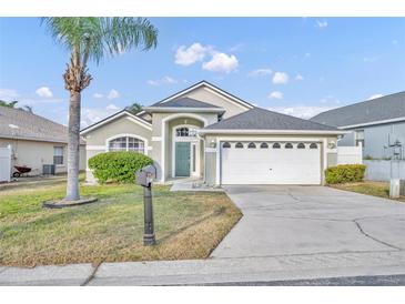 Charming single-story home featuring a two-car garage, a well-maintained lawn, and mature landscaping, providing excellent curb appeal at 314 Lady Diana Dr, Davenport, FL 33837
