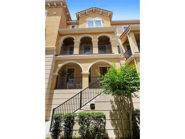 Charming three-story townhouse with arched entry, private balconies, and well-manicured landscaping at 3333 Messina Dr, Lake Mary, FL 32746