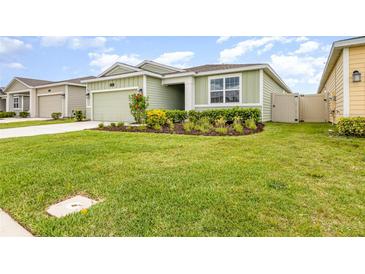 Charming one-story home featuring a well-manicured lawn and a neatly landscaped garden bed at 4351 Finch Ln, Kissimmee, FL 34746