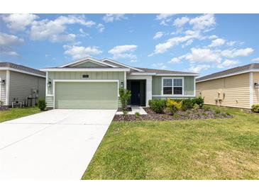 Charming single-story home with a well-manicured lawn and a two-car garage at 4351 Finch Ln, Kissimmee, FL 34746