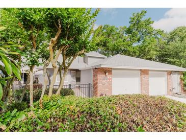 Charming townhome with lush landscaping, brick accents, and a two-car garage at 604 Chestnut Oak Cir # 106, Altamonte Springs, FL 32701