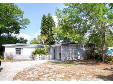 Charming single-story home featuring a unique concrete block design and lush landscaping at 704 Beverly Ave, Altamonte Springs, FL 32701