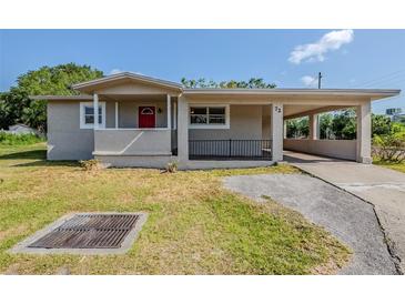 Charming single-story home featuring a carport, front porch, and well-maintained lawn at 72 Campus View Dr, Orlando, FL 32810