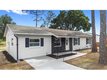 Charming single-story home with stone accents, fresh exterior paint, and updated landscaping at 14120 Rutgers Ave, Orlando, FL 32826