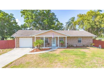 Charming single-story brick home featuring a well-maintained front yard and covered porch at 1620 Carolyn Ct, St Cloud, FL 34769
