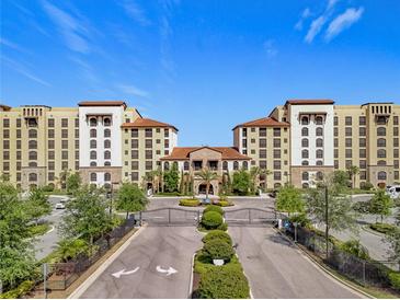 Stunning exterior view of a resort-style condo community, featuring lush landscaping and Mediterranean architecture at 16300 County Road 455 # 405, Montverde, FL 34756
