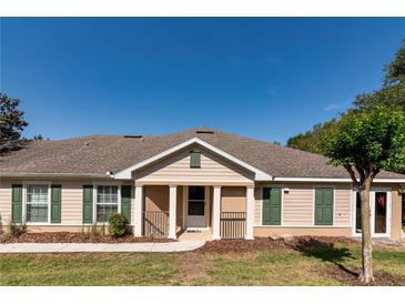 Charming single story home with beige siding, green shutters, and a welcoming front porch at 30546 Lipizzan Ter, Mount Dora, FL 32757