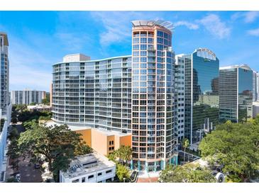 Stunning exterior view of a modern high-rise residential building with curved design and a glass facade at 322 E Central Blvd # 1909, Orlando, FL 32801