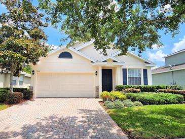 Charming single-story home featuring a two-car garage, manicured lawn, and well-maintained landscaping at 3506 Creswick Cir, Orlando, FL 32829