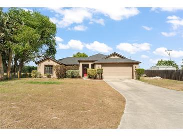 Charming single-story home featuring an attached garage and a well-manicured front yard at 43825 State Road 19, Altoona, FL 32702