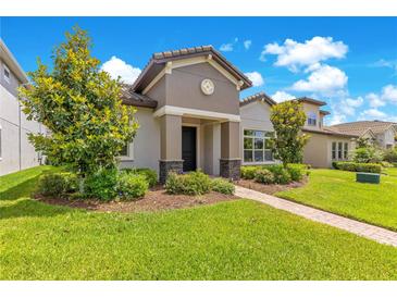 Charming single-Gathering home with a manicured lawn and beautiful landscaping at 9544 Mere Pkwy, Orlando, FL 32832