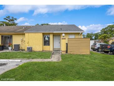 Inviting single-story home with a well-maintained lawn and a charming entrance in a sunny, residential area at 12102 Sandal Creek Way, Orlando, FL 32824