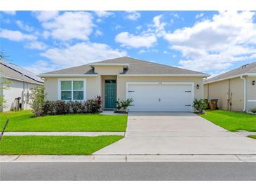 Charming single-story home with a well-maintained lawn and a two-car garage, creating great curb appeal at 1535 Barberry Dr, Kissimmee, FL 34744