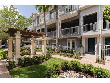Beautiful exterior of a three story townhome with well-manicured landscaping and small water feature at 1767 Piedmont Pl, Lake Mary, FL 32746