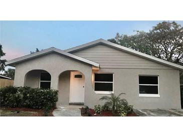 Charming single-story home featuring arched entry and a well-maintained, freshly landscaped front yard at 213 S Lake Pleasant Rd, Apopka, FL 32703