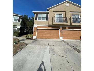 Two-story townhome with brown garages and balconies on the second floor at 2530 San Jacinto Cir # 2530, Sanford, FL 32771