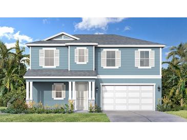 Charming two-story home featuring a light blue exterior, white trim, and a welcoming two-car garage at 30334 Emerald Forest Dr, Mount Dora, FL 32757