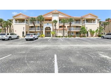 Attractive multi-level condominium building with ample parking and tropical landscaping at 446 Bouchelle Dr # 103, New Smyrna Beach, FL 32169