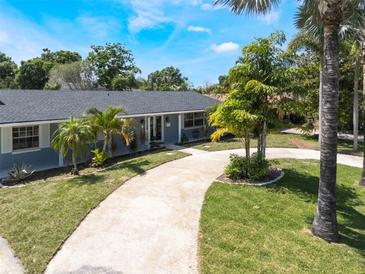 Charming single story home featuring a well-manicured lawn and a welcoming driveway at 5100 La Croix Ave, Belle Isle, FL 32812