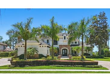 Elegant two-story home with lush landscaping and well-manicured lawn, offering great curb appeal at 5550 Osprey Isle Ln, Orlando, FL 32819