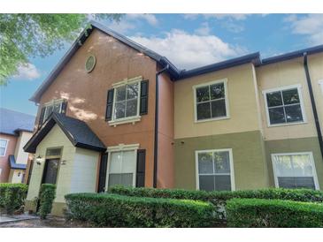Charming multi-toned townhouse exterior with well-maintained landscaping and classic architectural details at 5953 Westgate Dr # 1823, Orlando, FL 32835