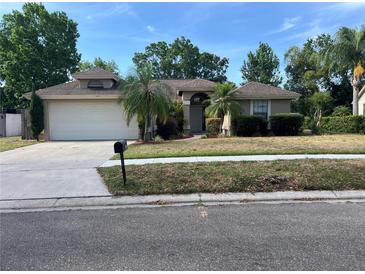 Charming single-story home with a well-manicured front yard and attached two-car garage at 840 Lake Jackson Cir, Apopka, FL 32703