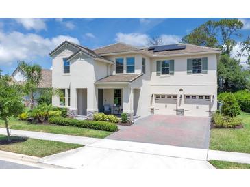 Charming two-story home boasts a manicured lawn, symmetrical design, and a convenient two-car garage at 8768 Sonoma Coast Dr, Winter Garden, FL 34787