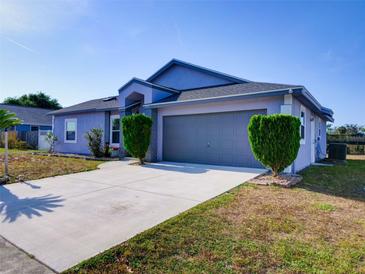 Charming single-story home with a well-maintained lawn and inviting two-car garage at 929 Monroe Harbor Pl, Sanford, FL 32773