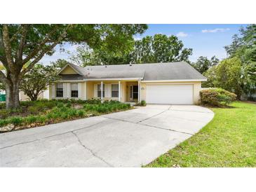 Charming single-story home with an attached two car garage, landscaped front yard, and inviting curb appeal at 1156 Brandy Lake View Cir, Winter Garden, FL 34787