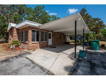 Brick home with a covered front entrance and driveway at 237 W Mcclendon St, Lady Lake, FL 32159