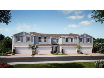 Charming townhome showcases traditional design with grey siding, shuttered windows, and welcoming two-car garages at 266 Thompson Village Ave, Apopka, FL 32703